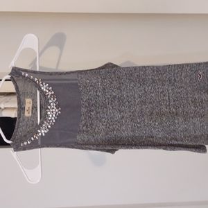 Gray tank top with beading around the neck.